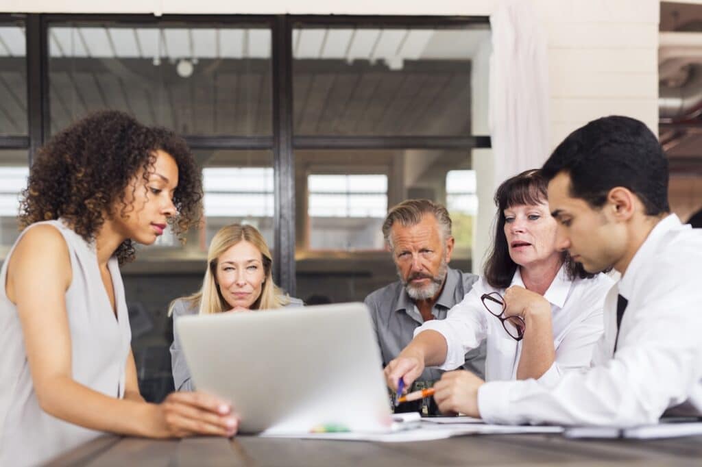 employees discussing outsourced it solutions