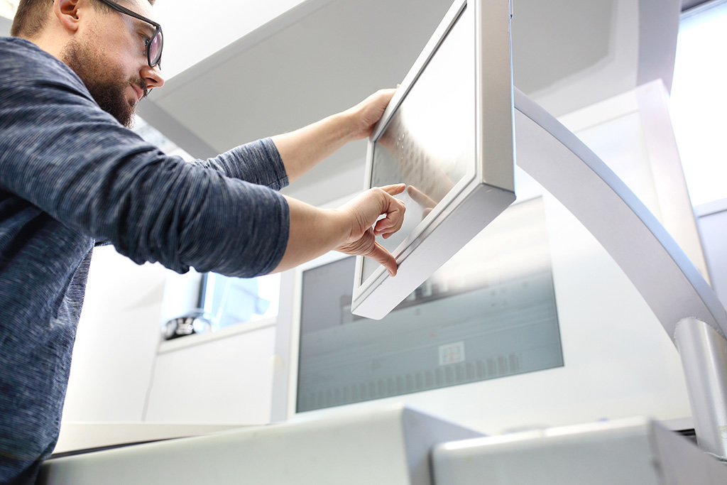 Man working on large printing machine